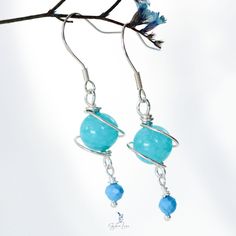 These cute dainty blue planet dangle drop earrings are made of authentic 925 sterling silver and an Amazonite jade bead with tiny facet turquoise stone drop at the end. Add these blue planet jade stone earrings to your everyday fine jewelry collection. They are light weight, delicate, cute and can wear everyday or send as a gift for your loved one. Material: 100% 925 Sterling Silver, Amazonite jade bead, facet turquoise beads Jewelry Care: See more information about how to care for your jewelry here. Shipping Policy: Orders will be shipped within 1-3 business days. Economy shipping will take 7-14 days to arrive and standard shipping is 1- 4 days for U.S. orders. International shipping time is depended on the country and per shipping method. Shipping cost will be calculated at check out.For Nickel-free Light Blue Sterling Silver Jewelry, Handmade Turquoise Aquamarine Earrings, Amazonite Natural Stone Earrings For Gifts, Turquoise Amazonite Dangle Earrings, Turquoise Dangle Earrings With Amazonite, Turquoise Apatite Gemstone Earrings, Handmade Turquoise Amazonite Earrings, Turquoise Amazonite Earrings For Gift, Hypoallergenic Amazonite Jewelry As Gift