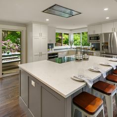 a large kitchen with an island in the middle