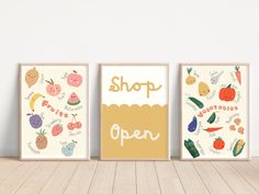 three framed art prints with the words shop open on them in front of a white wall