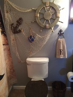 a bathroom with a toilet and some decorations on the wall