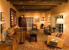 a living room filled with lots of furniture next to a fire place in a house