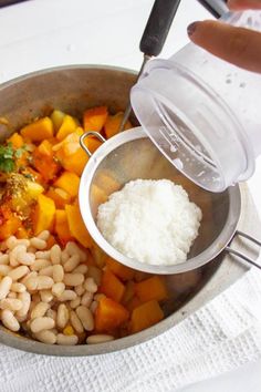 someone is adding seasoning to some food in a pan