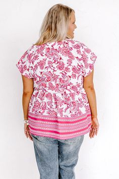 - Show your feminine side in this beautiful babydoll top! - Unlined, lightweight material with a fuchsia hued paisley pattern - A v-cut neckline with gathered detail at the back and shoulders - Short, loose sleeves - Button accents on the front - A relaxed silhouette that ends in a straight hemline Flowy Pink Top For Vacation, Flowy Pink Printed Tops, Pink Flowy Short Sleeve Top, Pink V-neck Top With Paisley Print, Pink Paisley Print V-neck Top, Casual Pink Paisley Print Tops, Bohemian Pink Paisley Print Tops, Loose Sleeves, Relaxed Jeans