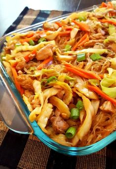 a glass casserole dish filled with noodles, meats and veggies