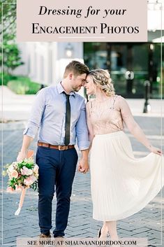 a man and woman holding hands while walking down the street with flowers in their hand