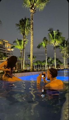 two people sitting in a swimming pool with palm trees around them and the words get you a man that finds your angles