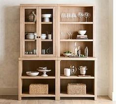 a wooden shelf filled with dishes and glasses