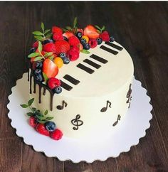 a cake decorated with fruit and music notes