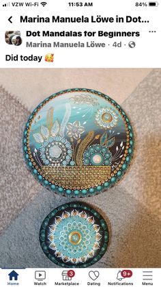 two small round tins with designs on them