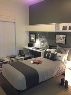 a bedroom with a bed, desk and shelves