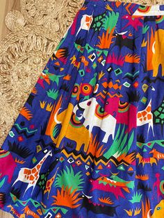 "Love this one so bright and cheerful. 80's Safari print midi skirt by Batya. Buttons on the side. Pockets at the hips. Bold colorful elephants, giraffes and antelope print. Purple, gold, black, green, and orange. Such a fun piece. In good vintage condition. Measurements taken while item was laying flat. Waist: 15\" Length: 35.5\"" Summer Multicolor Print Skirt, Fun Multicolor Skirt For Summer, Fun Multicolor Summer Skirt, Playful Multicolor Skirt With Elastic Waistband, Multicolor Retro Skirt For Vacation, Retro Multicolor Skirt For Vacation, Antelope Print, Colorful Giraffe, Ginger Dress