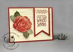 a close up of a card with a rose on it and a small metal object