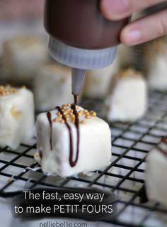 someone is adding chocolate to marshmallows on a wire rack with text overlay that reads the fast, easy way to make petitti fours