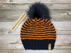 "I just love Fall, its the perfect time of year. Orange, yellow and reds leaves all over, the cold hits and you get to put on your favorite beanies! This one is one of them. Halloween themed wool beanie. Its the perfect touch for Fall. >>PLEASE READ<< COLORS → Black brim with orange and black stripes FUR POM COLOR → Shown in Black Fur Pom or can choose Black Yarn Pom >>SIZES << Newborn→ 13\" 3 Month → 16\" 6 Month → 17\" 12 Month → 18\" 2 Years Old → 19\" 3-5 Years Old → One Size Fits Most Hats As Fall Gift, One Size Hats For Fall Gift, Themed Black Costume Hats For Winter, Black Knitted Hat For Halloween, Themed Black Winter Hats, Winter Orange Hat, One Size Fits Most, Casual Knitted Halloween Hat, Halloween Beanie One Size Fits Most, Fun Black Warm Hats