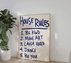 a house rules sign next to a potted plant