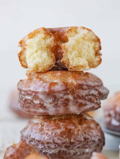 three donuts stacked on top of each other with one bite taken out of them