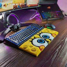 a desk with a keyboard, mouse and headphones on it