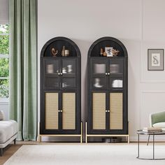 a living room with two black cabinets and a white rug in front of the couch