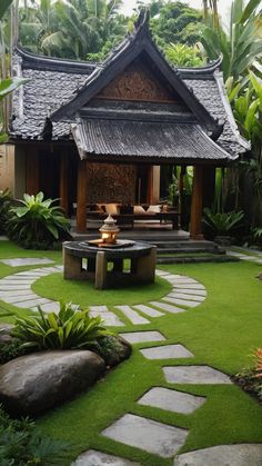 an outdoor living area with green grass and stepping stones in the foreground, surrounded by tropical trees