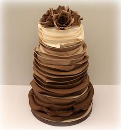 a stack of brown and white paper stacked on top of each other in the shape of a flower