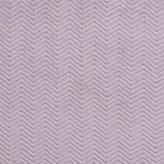 a close up view of a purple fabric textured with zigzag lines