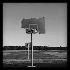 an empty basketball court with a broken backboard