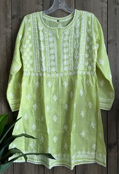 Short cotton A-line kurti with Chikankari hand Embroidery.  Length: 32 inches Pista Green Spring Kurta With Cutdana, Long Sleeve Kurta With Yoke For Eid, Eid Long Sleeve Kurta With Yoke Detail, Eid Kurta With Yoke Detail And Long Sleeves, Summer Anarkali Tunic With Resham Embroidery, Anarkali Tunic With Resham Embroidery For Summer, Spring Anarkali Long Sleeve Blouse, Festive Anarkali Tops For Spring, Bohemian Style Pista Green Kurta For Spring