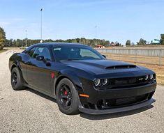 a black sports car is parked on the side of the road