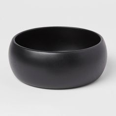 a black bowl sitting on top of a white table