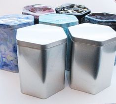 there are many tins on the table with different shapes and sizes in them,