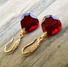 "Burgundy Garnet gold pave earrings. Heart cut garnets. Red stone jewelry. Red garnet dangles. Dark red garnet drops. Junuary birthstone. Available in 3 finishes. Length 1 1/4\". Dark red faceted gems are 14x14 mm as photo are sold, 19x14 mm and 13x17 mm stones are available. These beautiful earrings will arrive in a jewelry box ready for gift giving." Ruby Gemstone Earrings As Gift, Lab-created Ruby Gemstone Earrings As Gift, Ruby Jewelry With Earrings For Valentine's Day, Lab-created Ruby Gemstone Earrings For Gift, Red Heart Cut Elegant Earrings, Elegant Red Heart Cut Earrings, Valentine's Day Ruby Jewelry With Matching Earrings, Valentine's Day Drop Earrings Gift, Ruby Teardrop Jewelry For Valentine's Day