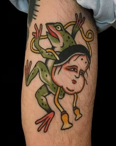 a man with a frog tattoo on his leg