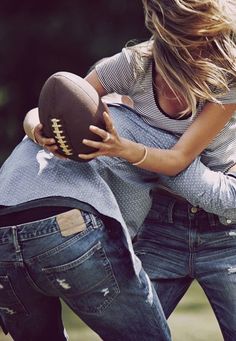 two people are playing with a football in black and whit photo by the same person