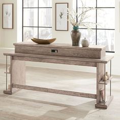 a wooden table sitting in front of two vases on top of a hard wood floor