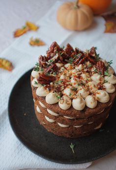 a chocolate cake with pecans and nuts on top