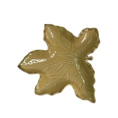 a brown leaf shaped dish on a white background