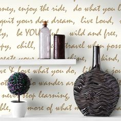 two white shelves with vases on top of them and wallpaper in the background