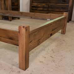 a wooden bed frame sitting on top of a floor