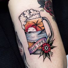 a tattoo on the arm of a woman with a mug of beer in it that says good times