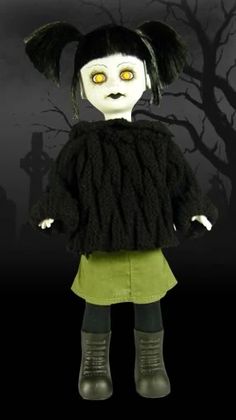 a creepy doll with yellow eyes standing in front of a tree