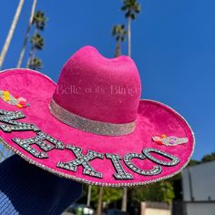 "Hat color: fuchsia pink  Hat material: suede Hat size: M or L -Beautifully adorned with crystal AB rhinestones on the bottom brim -The back part of the hat says \"MEXICO\" and has 2 sugar skulls with flowers perfect for representing at any Mexican celebration such as cinco de mayo, dia de los muertos, and more! Stand out and sparkle in style <3 Follow me on Instagram: @BelleoftheBlingco for more inspo!" Adjustable Felt Hat For Summer Party, Pink Mini Hats With Flat Brim For Party, Pink Wide Brim Costume Hat For Festival, Adjustable Pink Felt Hat For Summer, Pink Wide Brim Mini Hat For Festival, Pink Hat For Kentucky Derby Festival, Pink Flat Brim Mini Hats For Party, Pink Adjustable Felt Hat For Summer, Pink Wide Brim Hat For Festival