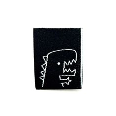 a black and white patch with a face drawn on it