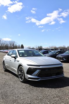 a white car parked in a parking lot next to other cars