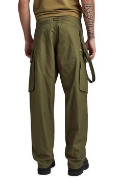 These loose-fitting, military-inspired twill pants feature roomy cargo pockets and woven tape inside the hems that can be adjusted to slightly taper the legs. Zip fly with button and drawstring closure Front slant pockets; side flap-patch zip pockets; back welt pockets 100% cotton Machine wash, line dry Imported Combat Style Wide Leg Parachute Pants With Side Pockets, Khaki Wide Leg Combat Cargo Pants, Military Style Baggy Pants With Patch Pockets, Combat Style Khaki Pants With Cargo Pockets, Combat Style Cargo Pants With Hip Pockets, Khaki Combat Pants With Cargo Pockets, Combat Cargo Pants With Multiple Pockets, Khaki Parachute Pants For Streetwear With Belt Loops, Khaki Parachute Pants With Belt Loops For Streetwear