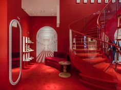 a room with red walls and white stairs