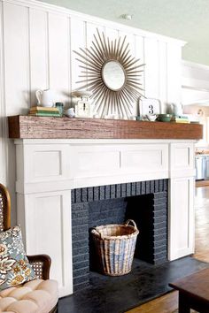 a living room filled with furniture and a fire place in front of a white fireplace