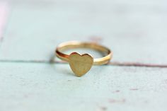 This is a very sweet, tiny, vintage ring. It has never been worn and is in new condition. The heart measures just 8mm tall and the band is about 1-2mm. It is adjustable but fits a small finger best. The ring can fit a size 4-5.5 best. This also makes a great pinky ring! 14K Gold Plated. --Shop Policies-- Please be sure to read our shop policies before making your purchase. Thank you! https://www.etsy.com/shop/diamentdesigns/policy Cute Heart-shaped Promise Ring, Cute Heart-shaped Ring For Anniversary, Cute Heart Ring For Anniversary, Vintage Heart Shaped Promise Ring, Tiny Heart Ring For Wedding, Heart Ring Gold, Gold Heart Ring, Ring Heart, Midi Ring