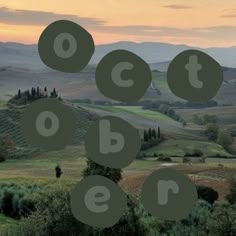 an aerial view of the countryside with trees and hills in the distance, surrounded by circles that spell out letters