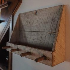 an old wooden box is hanging on the wall