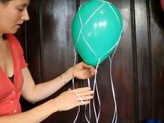 a woman holding a green balloon in her hand